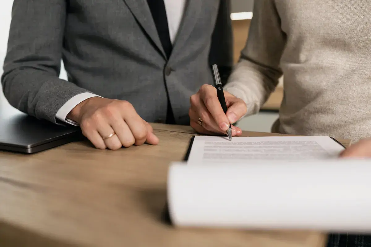 Business man signing a contract after securing a mortgage deal