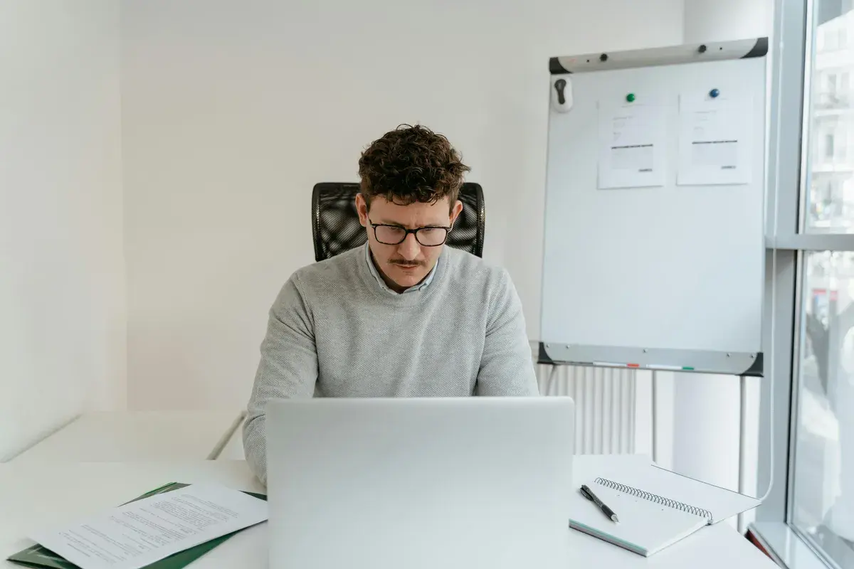 Broker cheking his earnings on laptop