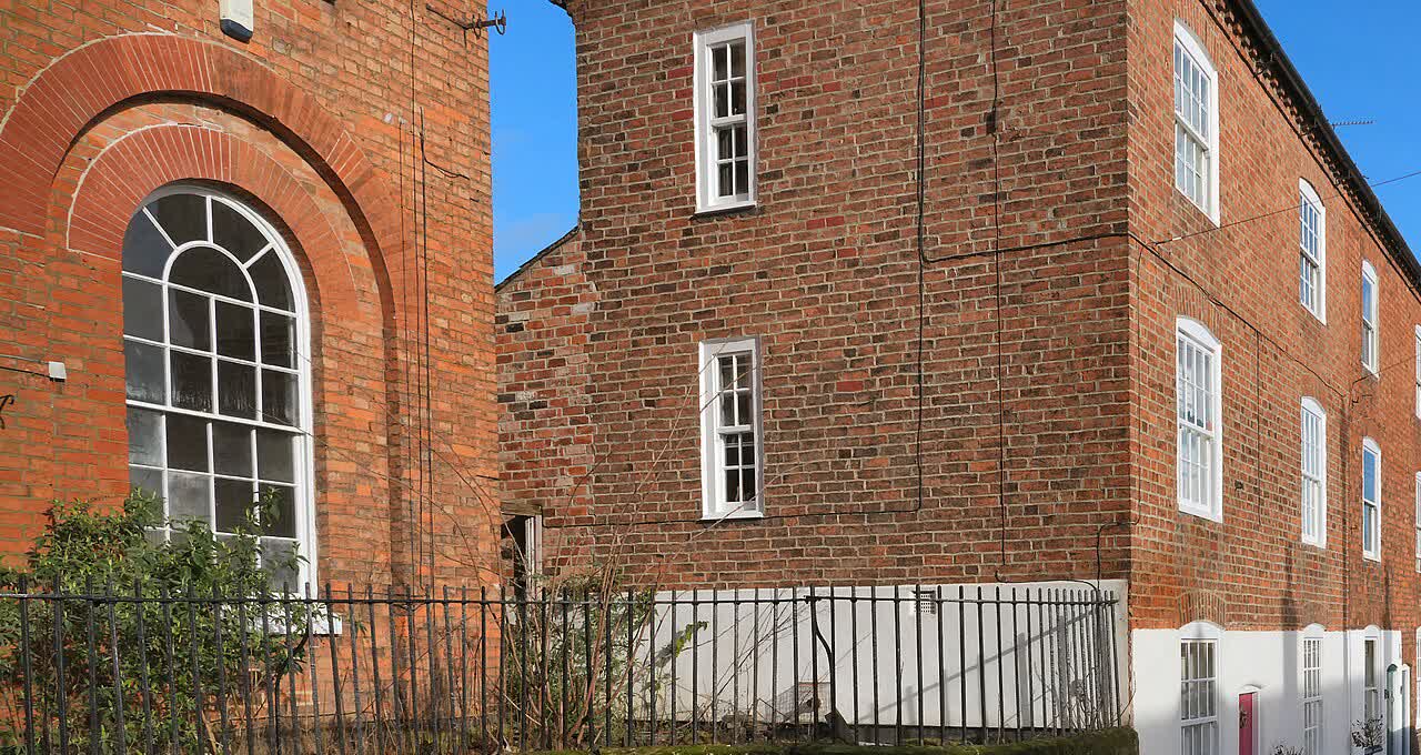 Red-brick British terrace houses and a clear sky